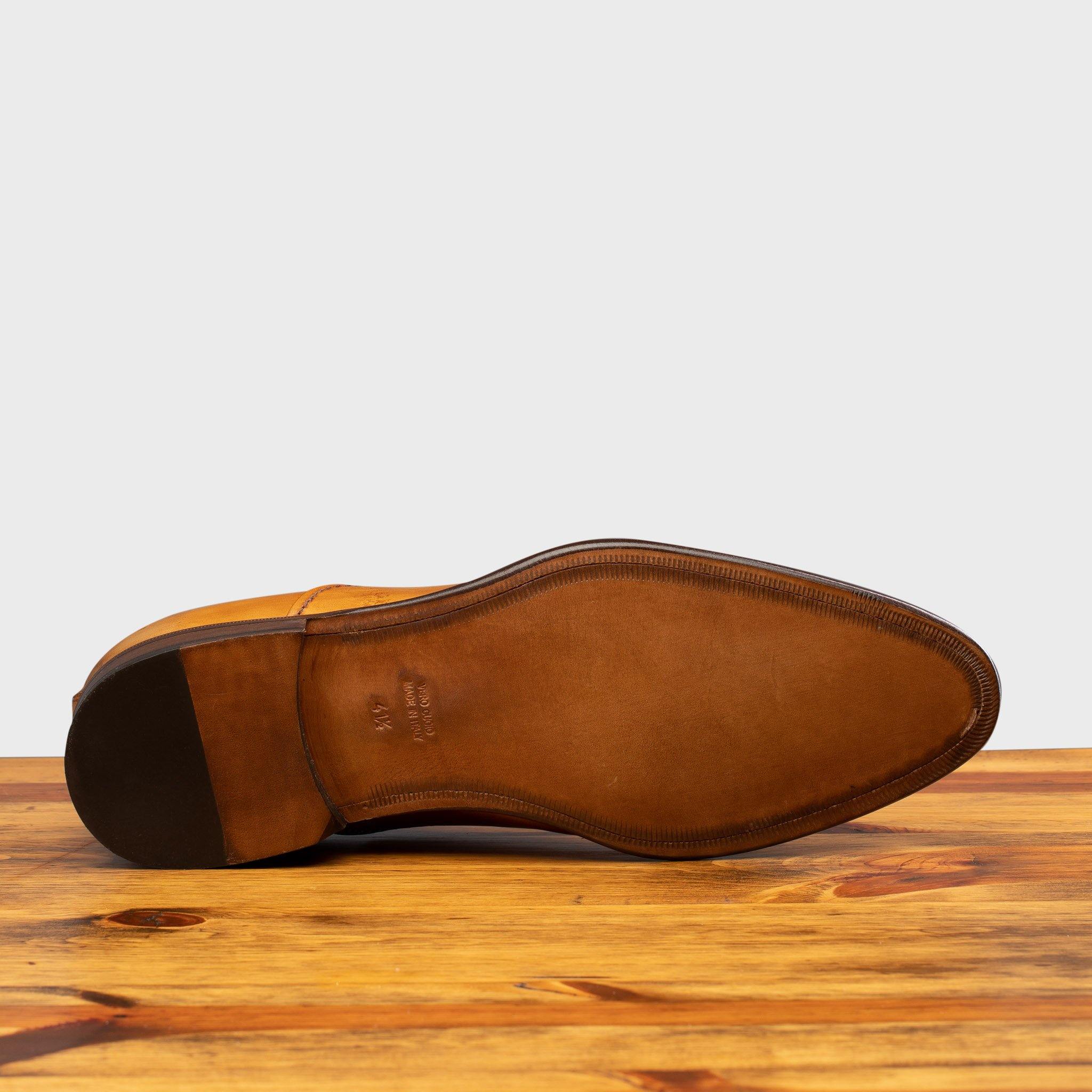 Full leather outsole of the 2361 Calzoleria Toscana Dark Caramel Cayenne Calf Cap-Toe on top of a wooden table