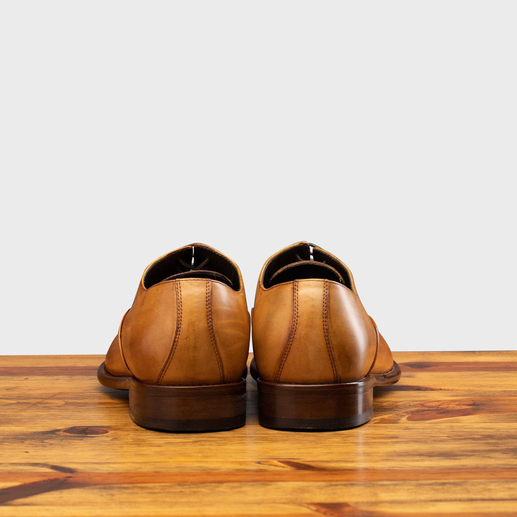 Back profile of the 2361 Calzoleria Toscana Dark Caramel Cayenne Calf Cap-Toe on top of a wooden table