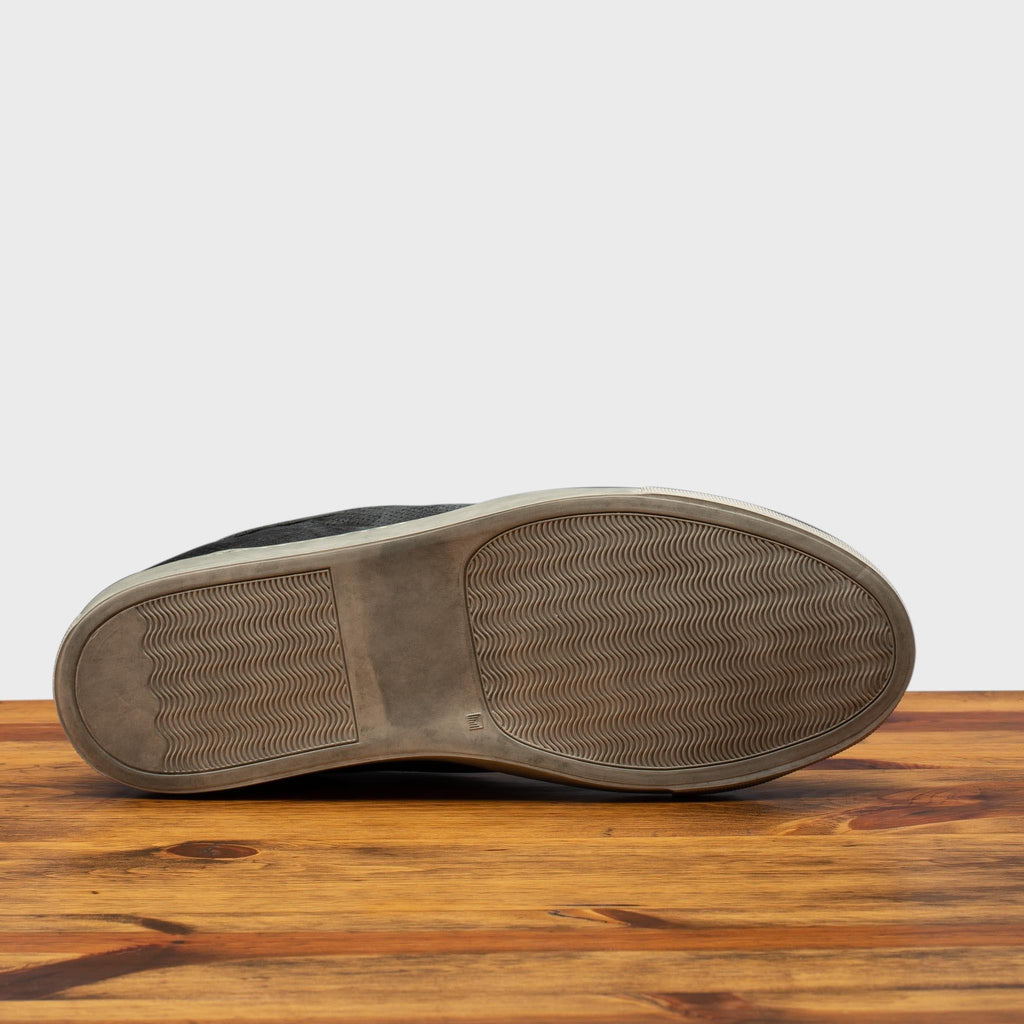 Full Rubber Outsole of the 3042 Calzoleria Toscana Black Benso sneaker on top of a wooden table