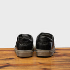 Back profile of the 3042 Calzoleria Toscana Black Benso sneaker on top of a wooden table