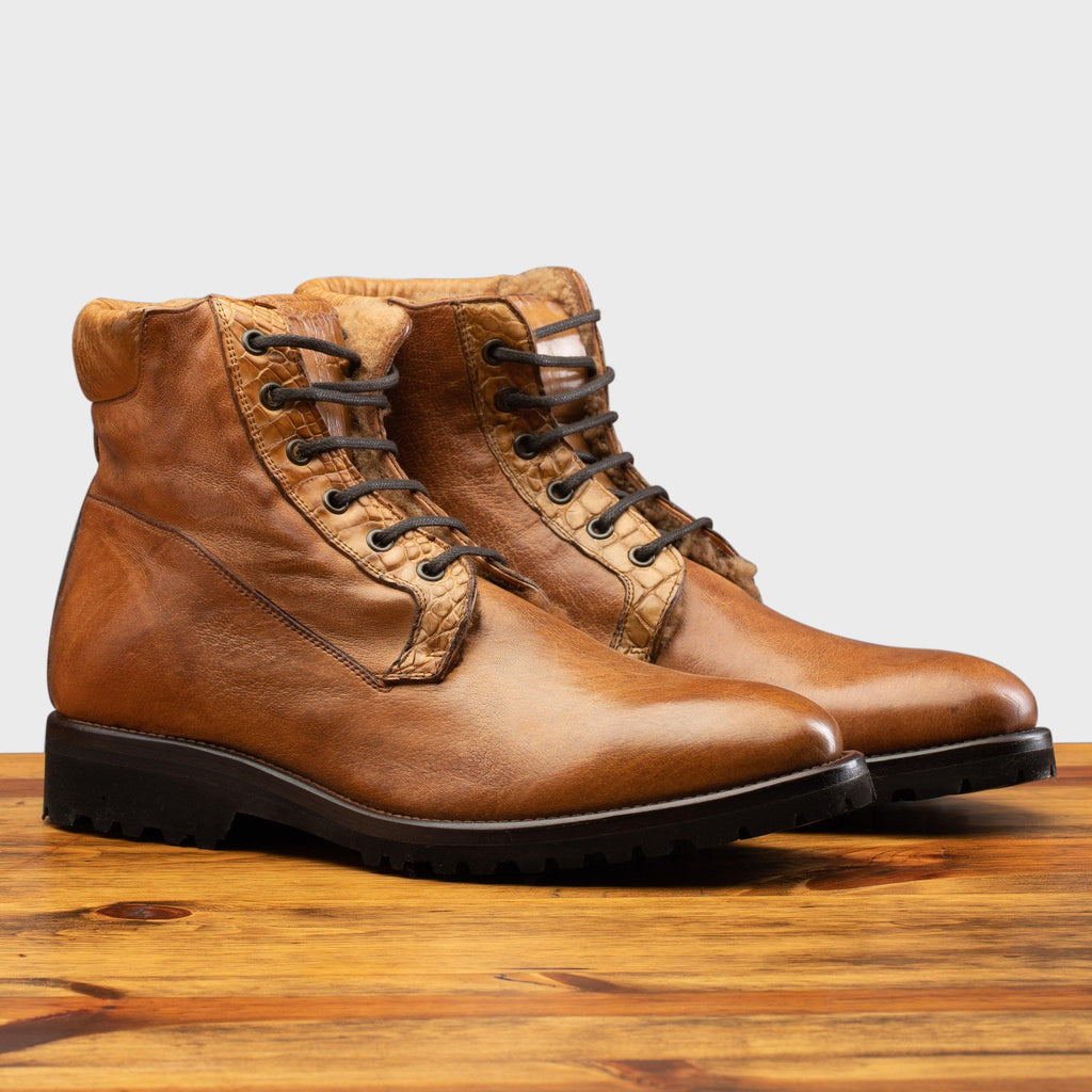 Pair of the 3236 Calzoleria Toscana Brick Shearling Boot on top of a wooden table