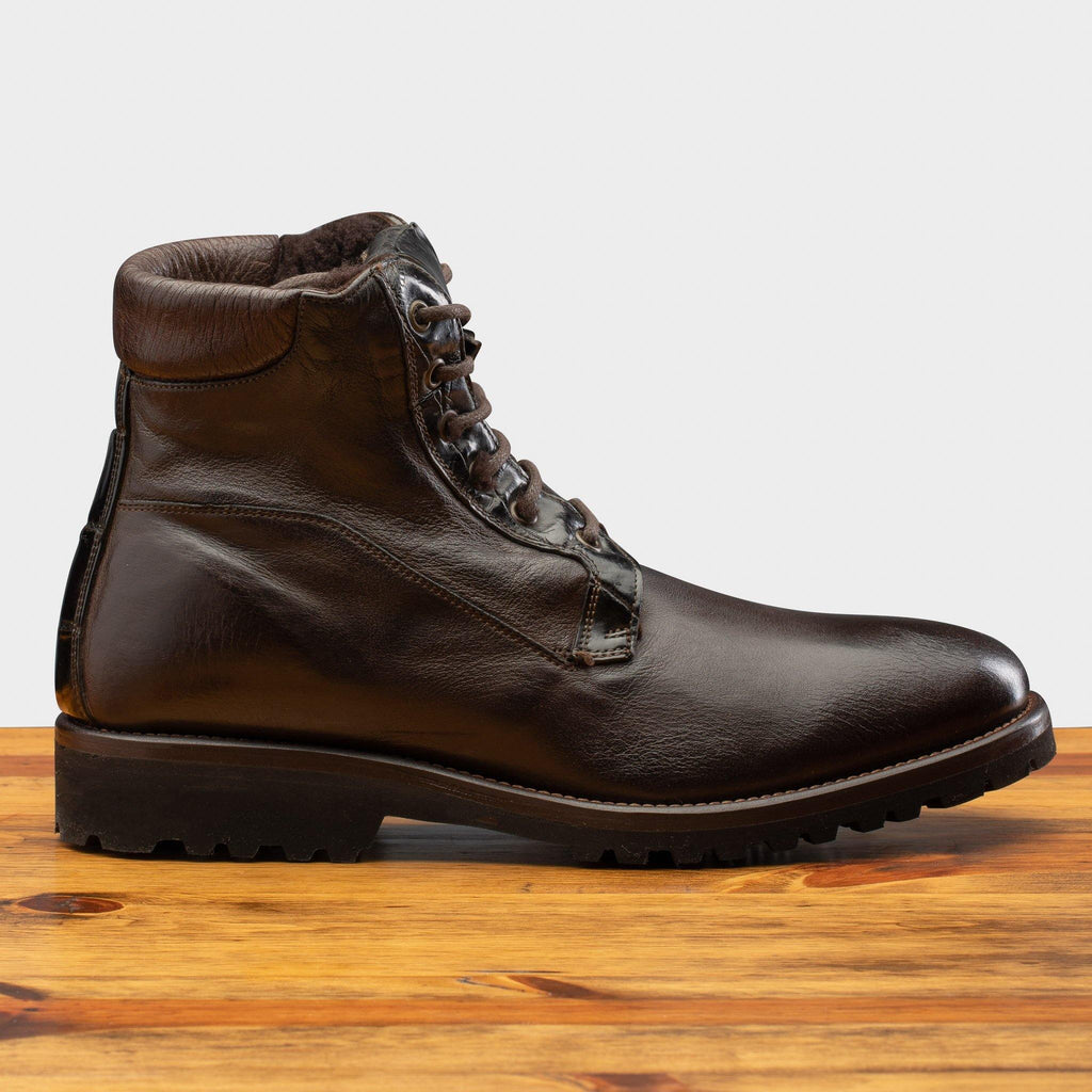 Side profile of the 3236 Calzoleria Toscana Dark Brown Shearling Boot on top of a wooden table