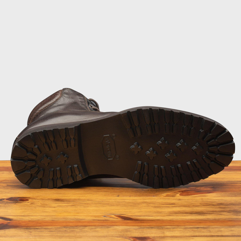 Full Rubber Vibram Outsole of the 3236 Calzoleria Toscana Dark Brown Shearling Boot on top of a wooden table