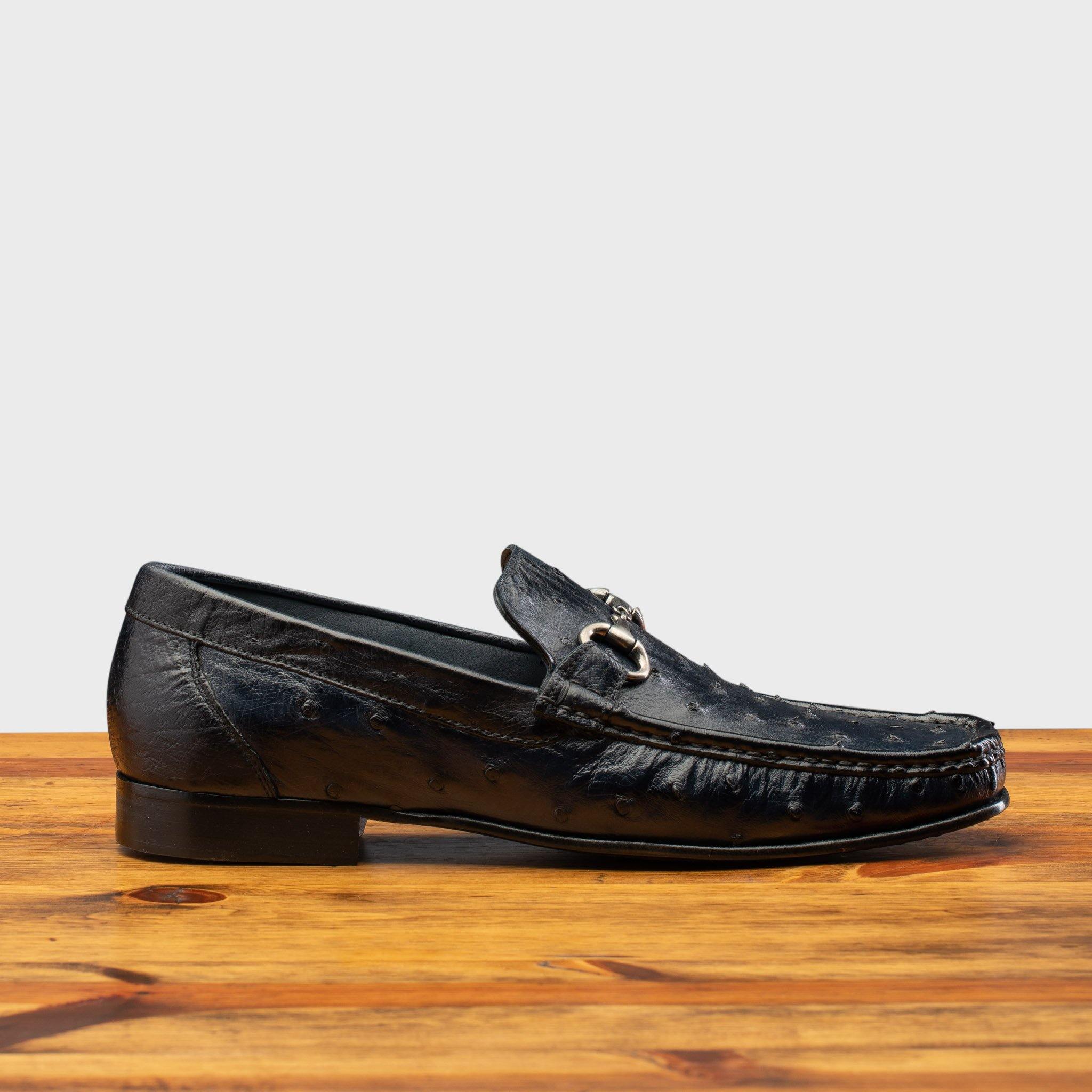 Side profile of the 3238-M Calzoleria Toscana Ostrich Dress Slip-On on top of a wooden table