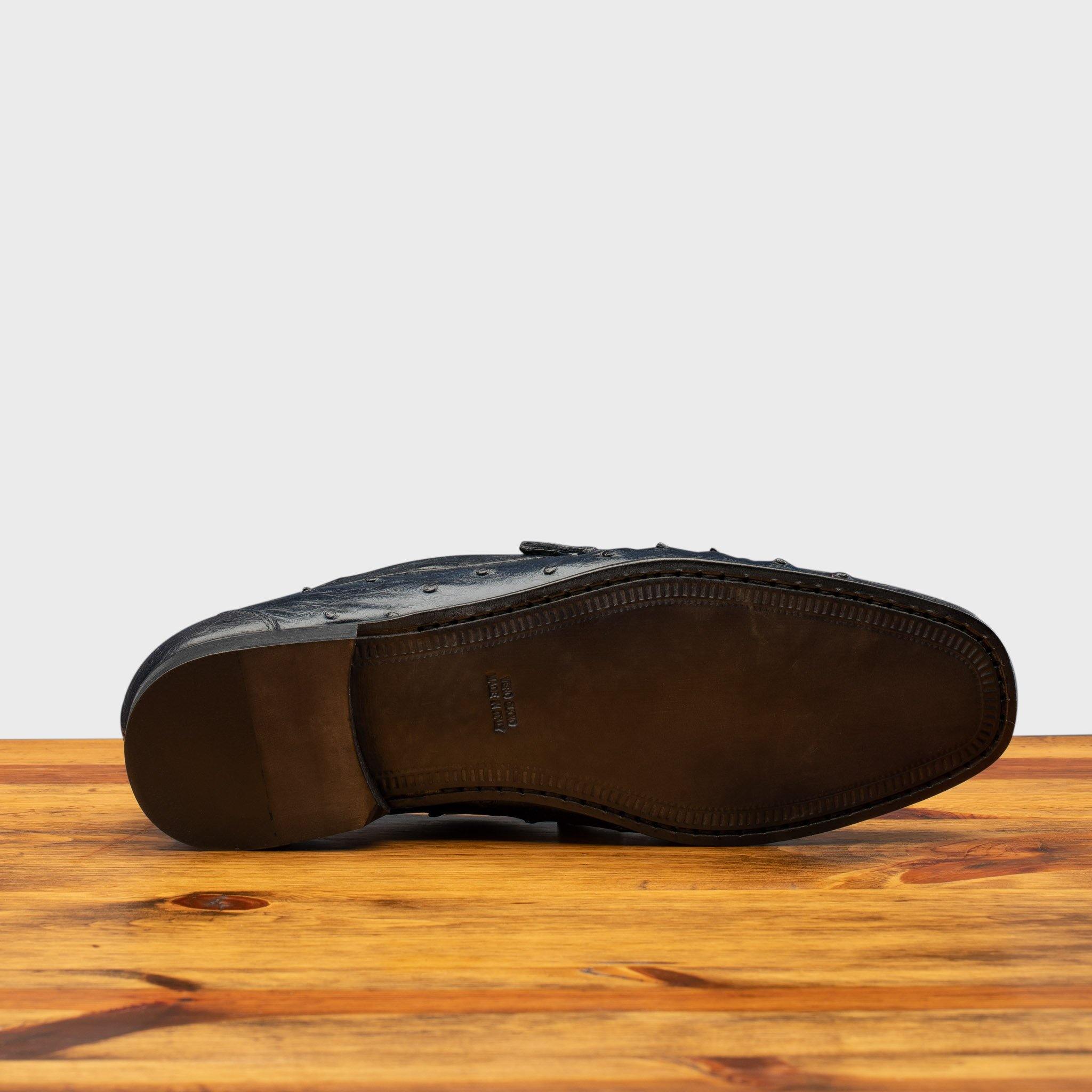 Full leather outsole of the 3238-M Calzoleria Toscana Ostrich Dress Slip-On on top of a wooden table