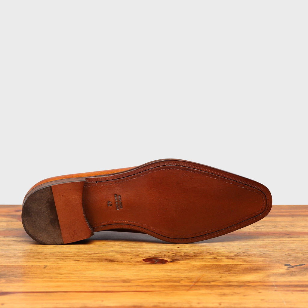 Full leather outsole of 4633 Calzoleria Toscana Dark Caramel Cayenne Calf Wholecut Balmoral on top of a wooden table