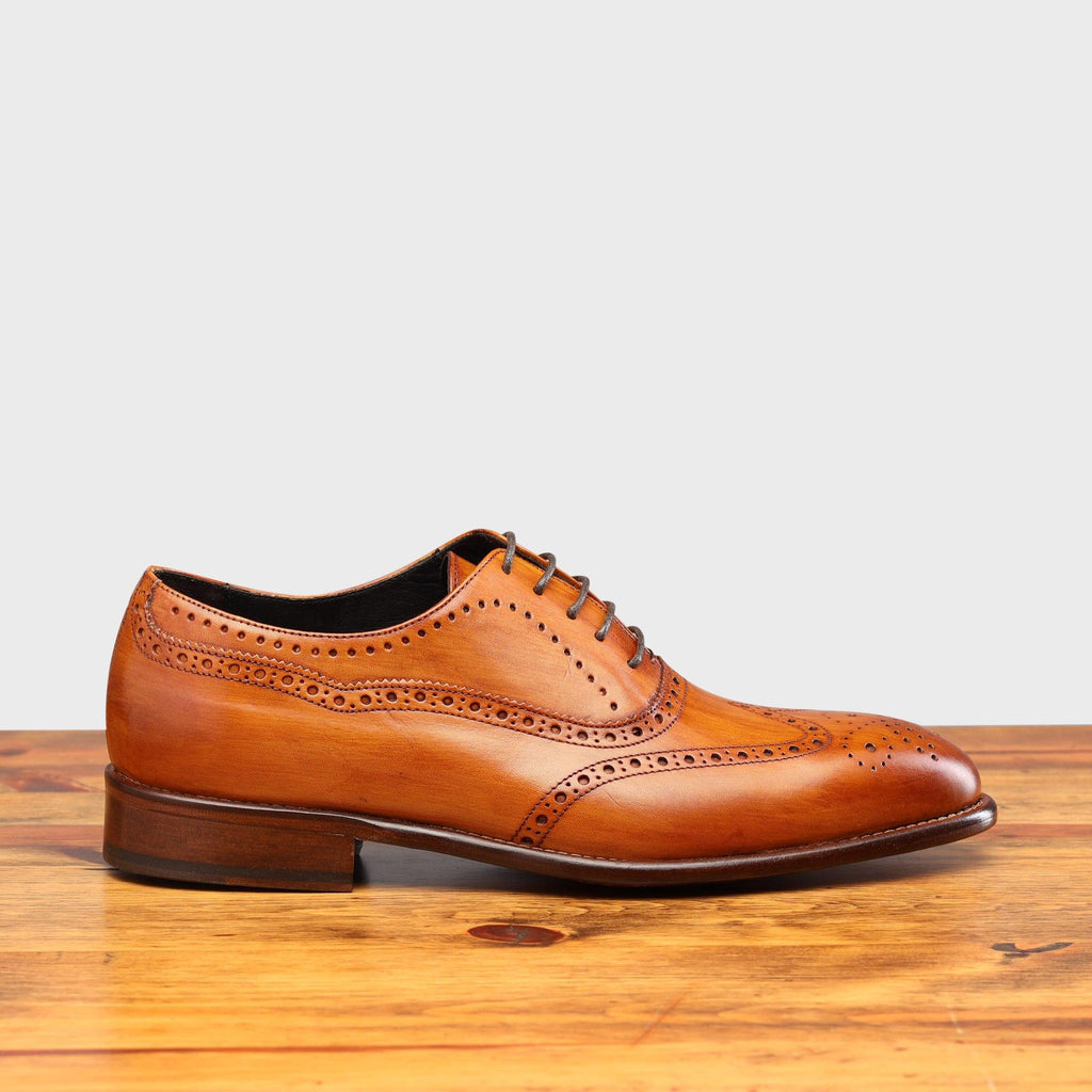 Side profile of H742 Calzoleria Toscana Dark Caramel Balmoral Lace-up on top of a wooden table