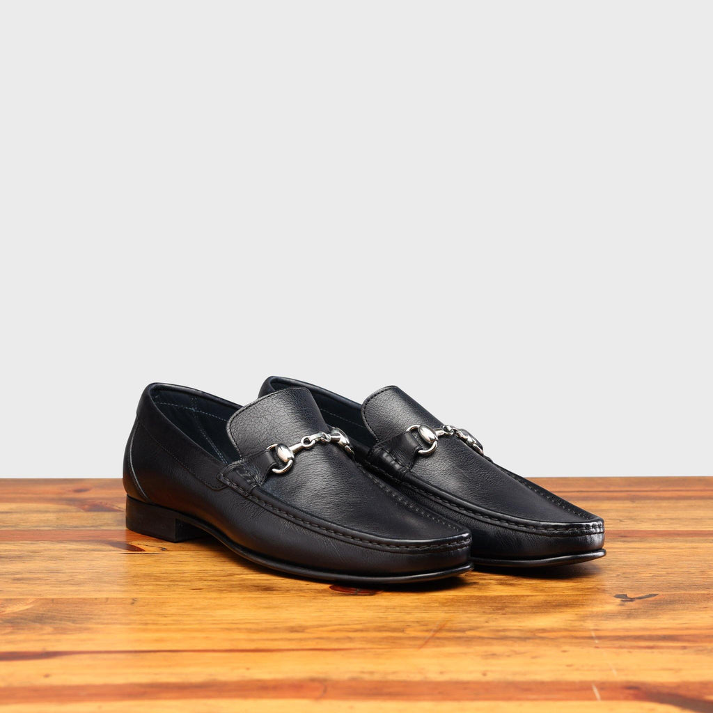 Pair of 8616-M Calzoleria Toscana Blue Buff Calf Slip-On on top of a wooden table