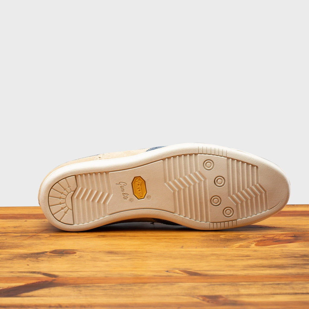 Full Vibram Gumlight Outsole of 4445 Calzoleria Toscana Suede Slip-On on top of a wooden table