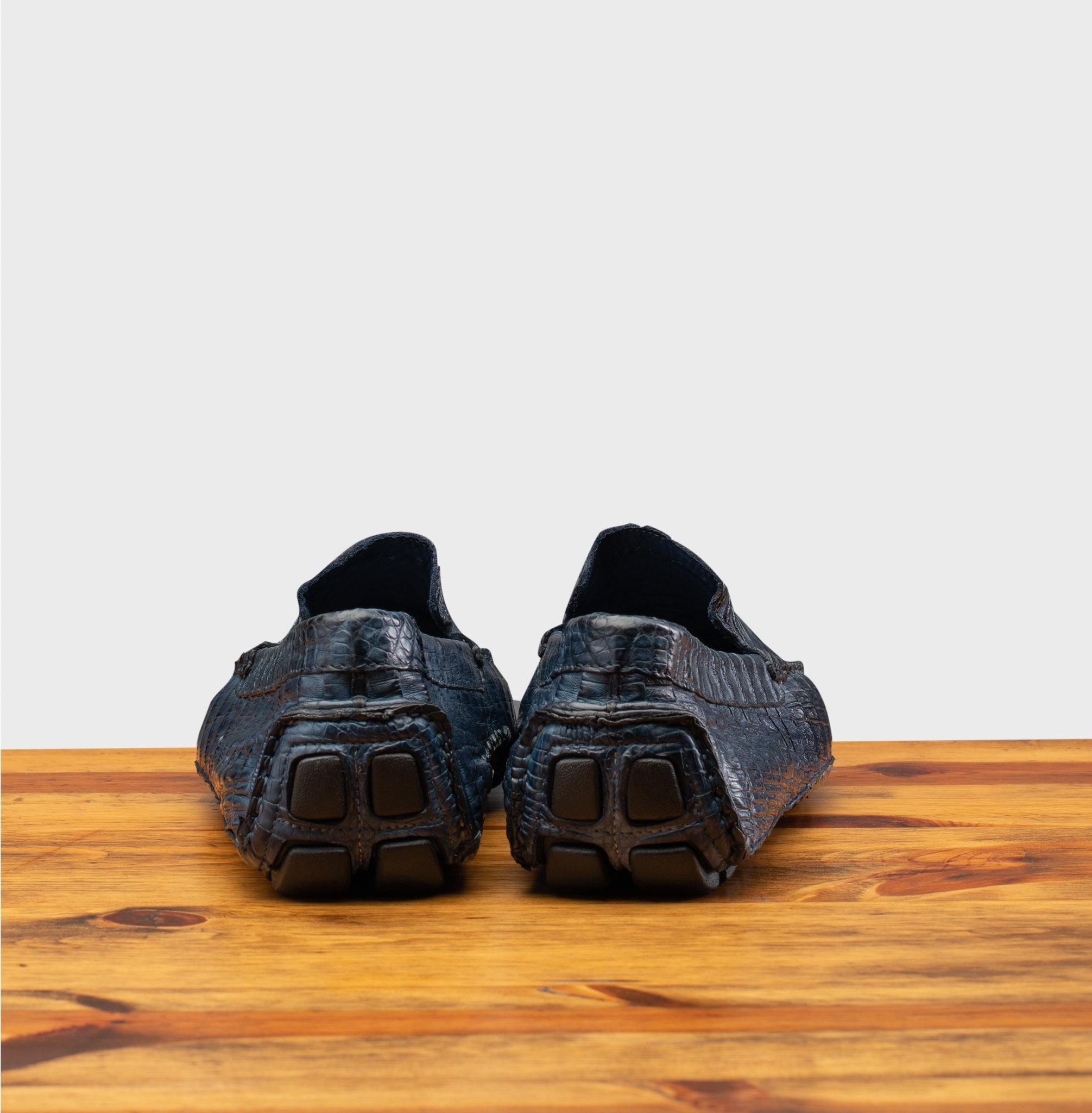 Back profile of the 4551 Calzoleria Toscana Denim Blue Crocodile Dip-Dyed Driver on top of a wooden table