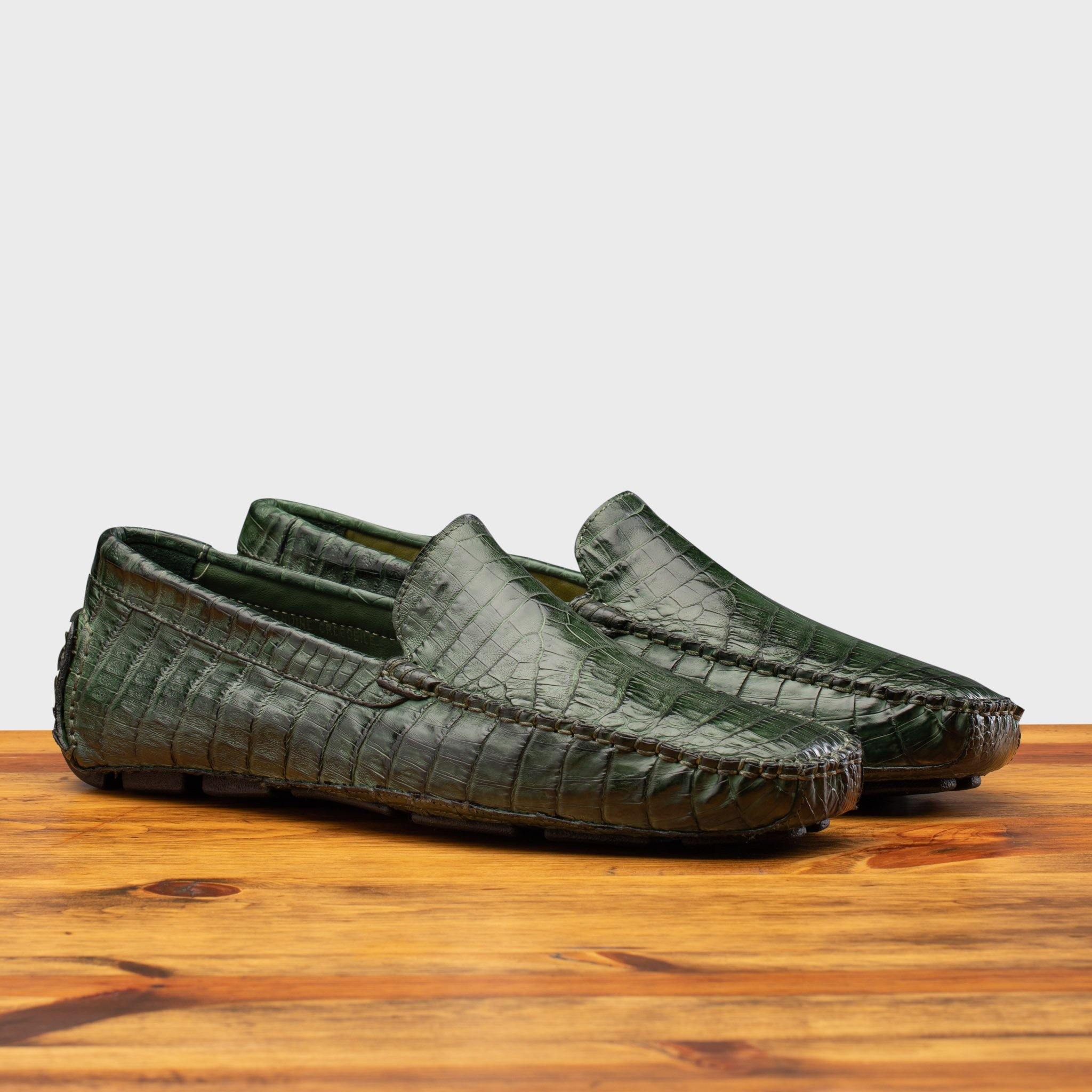 Pair of the 4551 Calzoleria Toscana Green Crocodile Dip-Dyed Driver on top of a wooden table