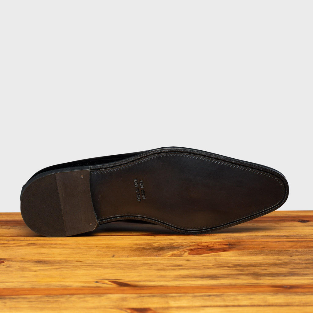 Full leather outsole of 4870 Calzoleria Toscana Blue David Wholecut on top of a wooden table