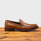 Side profile of 5034 Calzoleria Toscana Mahogany Crocodile Slip-On on top of a wooden table