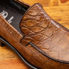 Close view of Mahogany leather loafer on a wooden surface