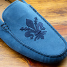 Up close picture of the tone on tone embroidered fleur de Lis on 5303 Calzoleria Toscana Denim Blue Venetian Suede Driver 