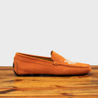 Side profile of 5303 Calzoleria Toscana Papaya Venetian Suede Driver on top of a wooden table
