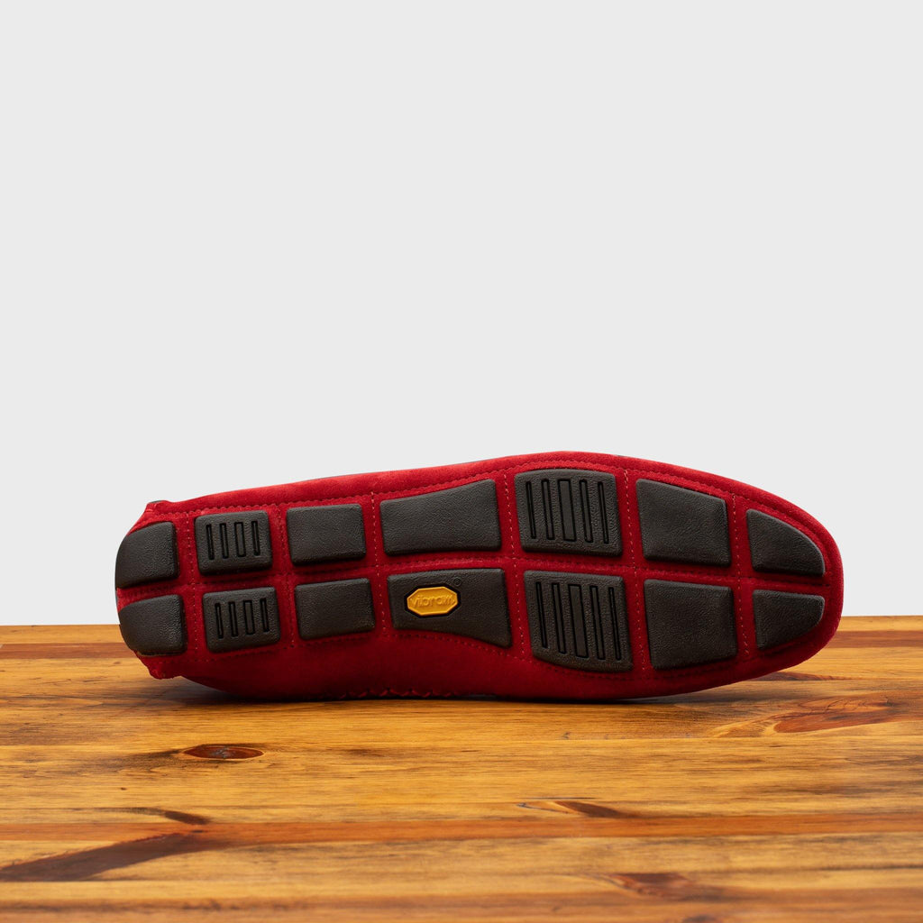 Full Rubber Vibram Outsole of 5303 Calzoleria Toscana Red Venetian Suede Driver on top of a wooden table