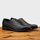 Pair of 5373 Calzoleria Toscana Black Woven Lace-up on top of a wooden table