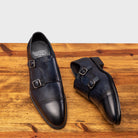 Picture showcasing the 6582 Calzoleria Toscana Blue Monkstrap Cap Toe with the brand name insole showing on top of a wooden table