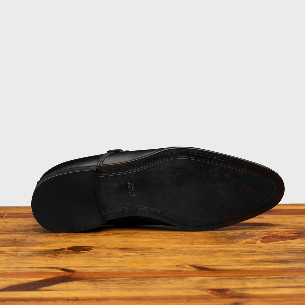 Full leather outsole of 6582 Calzoleria Toscana Black Monkstrap Cap Toe on top of a wooden table