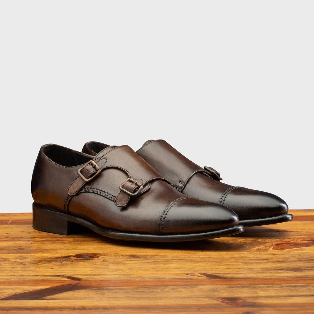 Pair of 6582 Calzoleria Toscana Moor Monkstrap Cap Toe on top of a wooden table