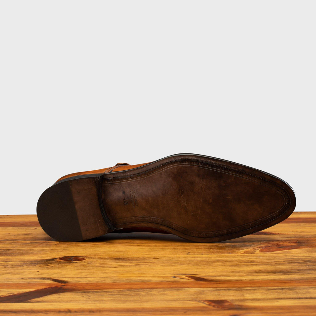 Full leather outsole of 6582 Calzoleria Toscana Dark Caramel Monkstrap Cap Toe on top of a wooden table