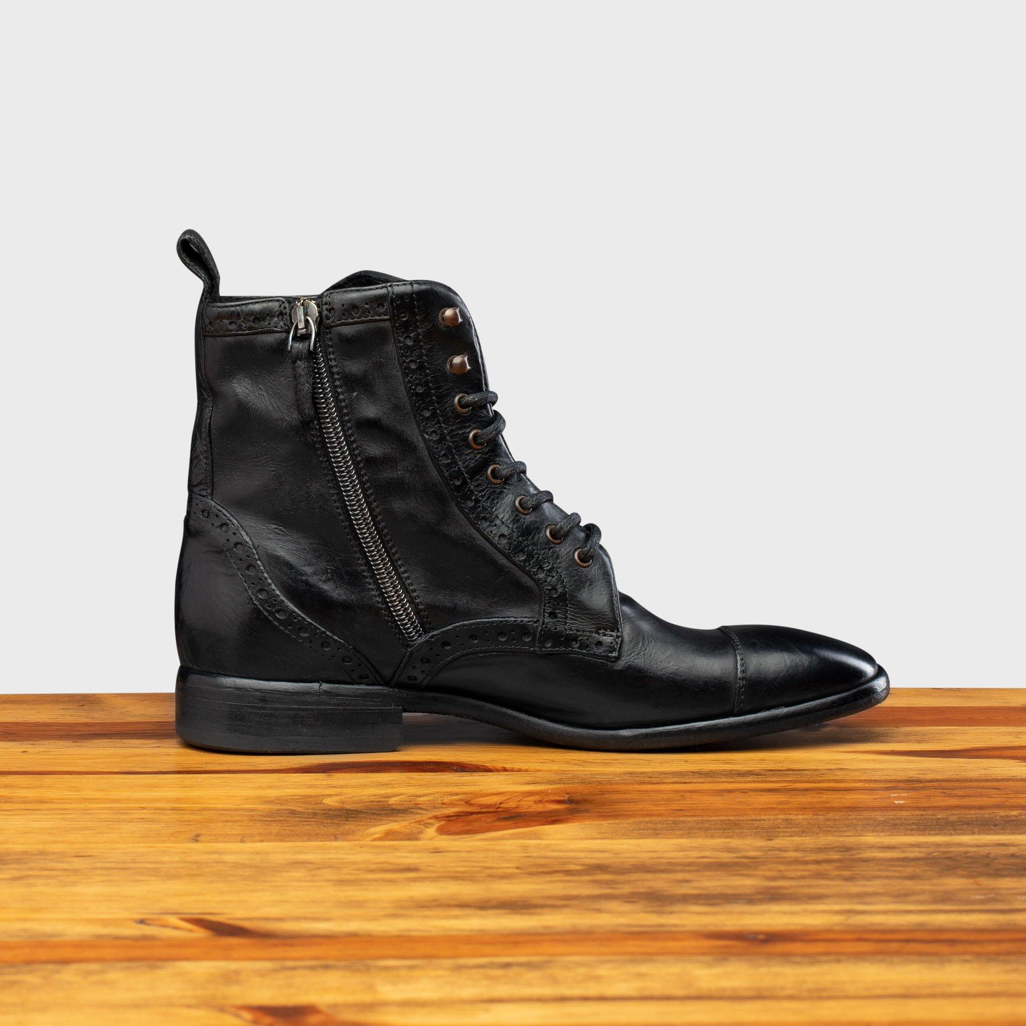 Side profile of 7149 Calzoleria Toscana Women's Black Dip-Dyed Diver Combat Boot on top of a wooden table