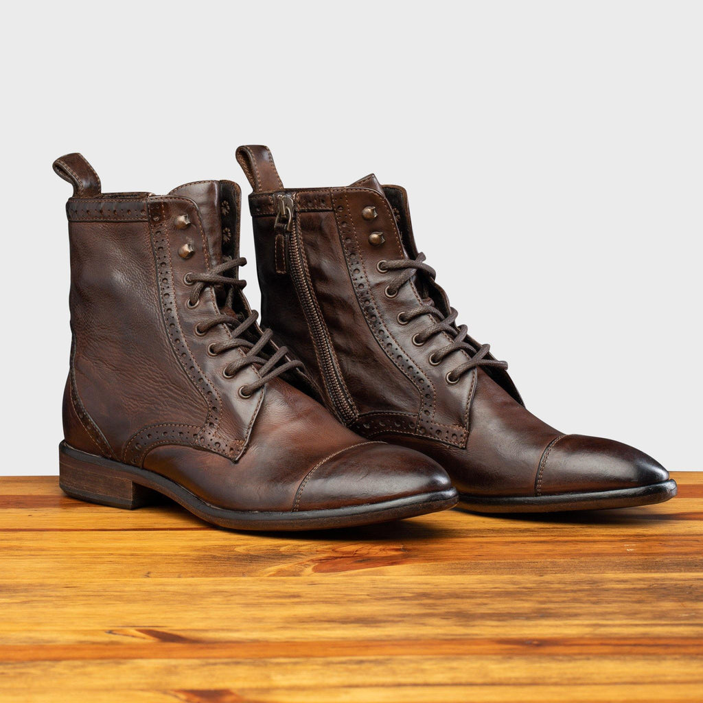 Pair of 7149 Calzoleria Toscana Women's Brown Dip-Dyed Diver Combat Boot on top of a wooden table