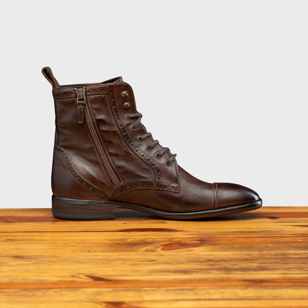 Side profile of 7149 Calzoleria Toscana Women's Brown Dip-Dyed Diver Combat Boot on top of a wooden table