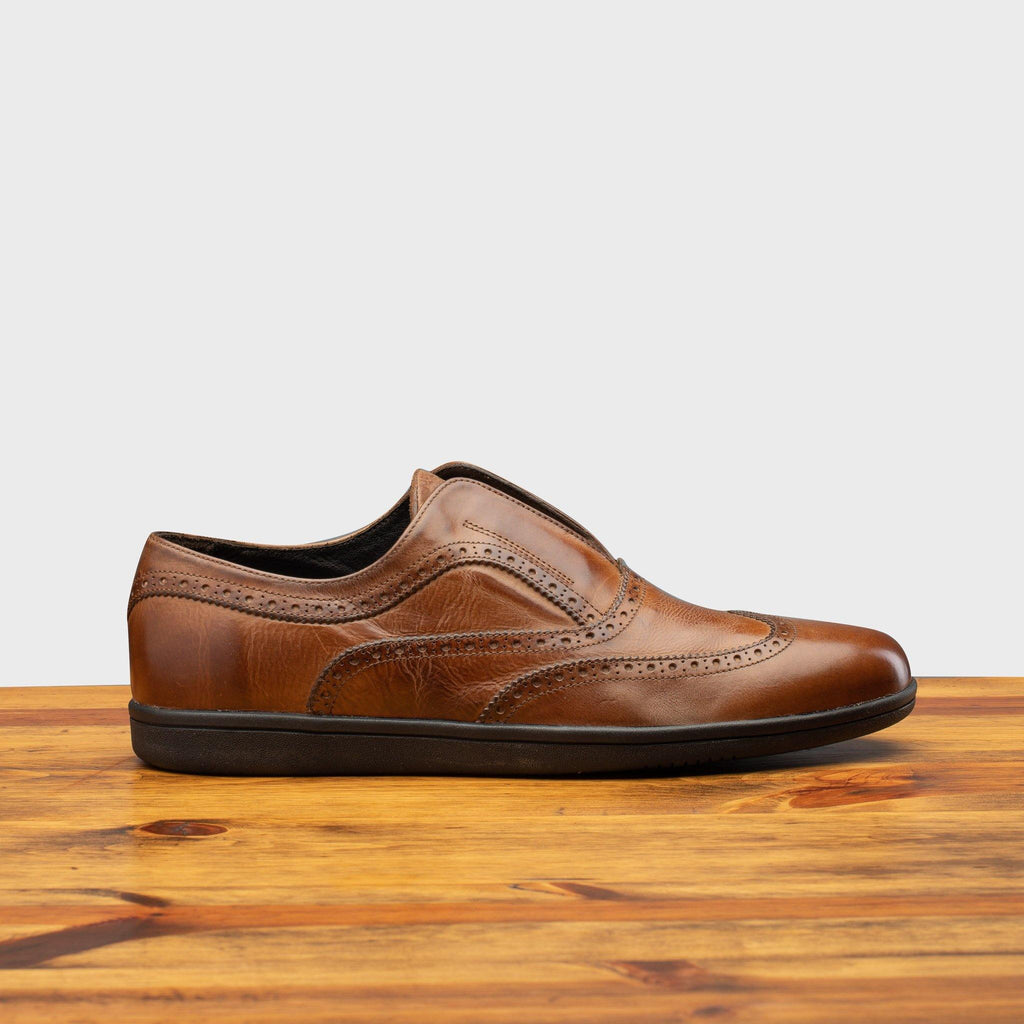 Side profile of 7839 Calzoleria Toscana Cerris Elba Slip-On on top of a wooden table