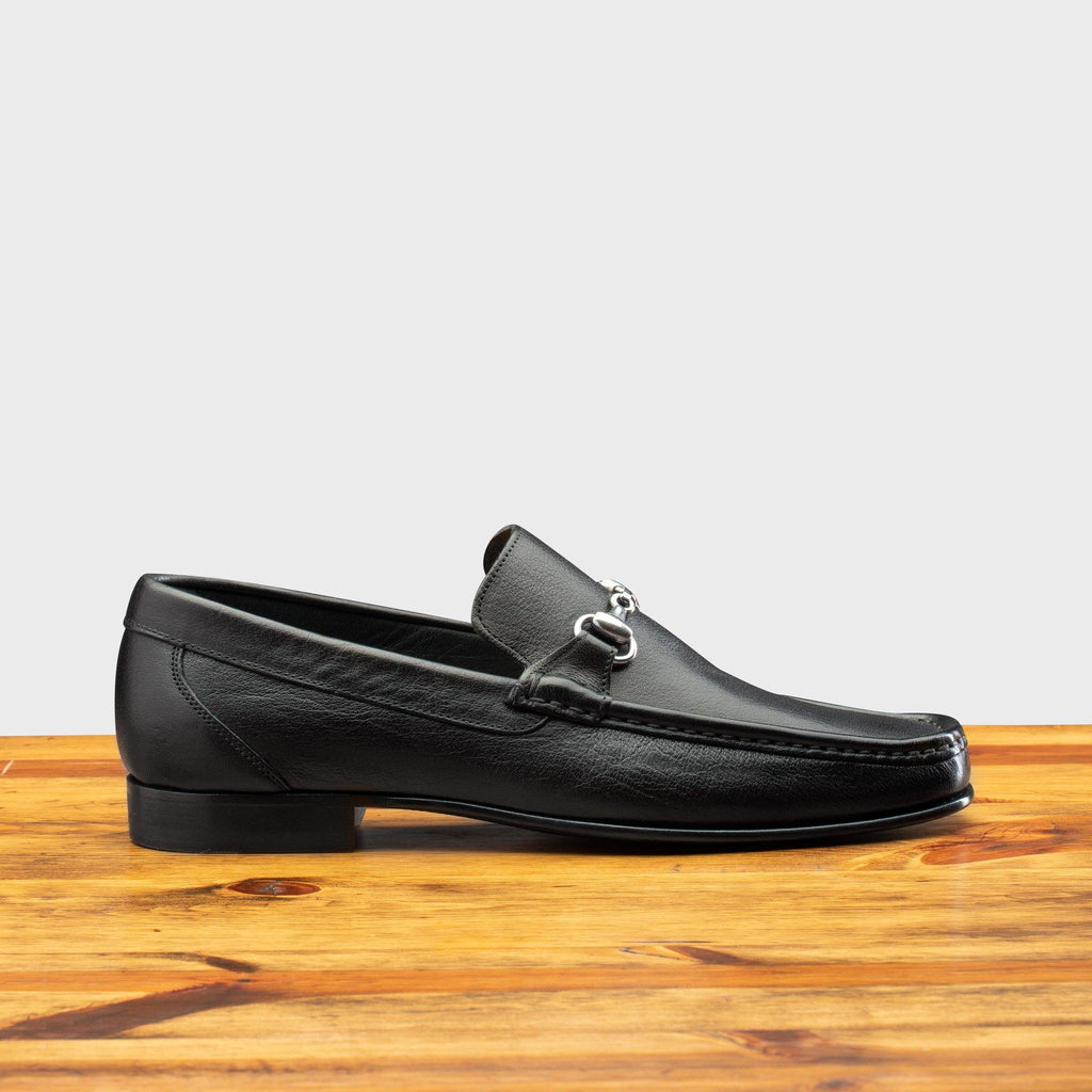 Side profile of 8616-M Calzoleria Toscana Black Buff Calf Slip-On on top of a wooden table