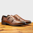 Pair of 8863 Calzoleria Toscana Chestnut Cayenne Calf Double Monstrap on top of a wooden table