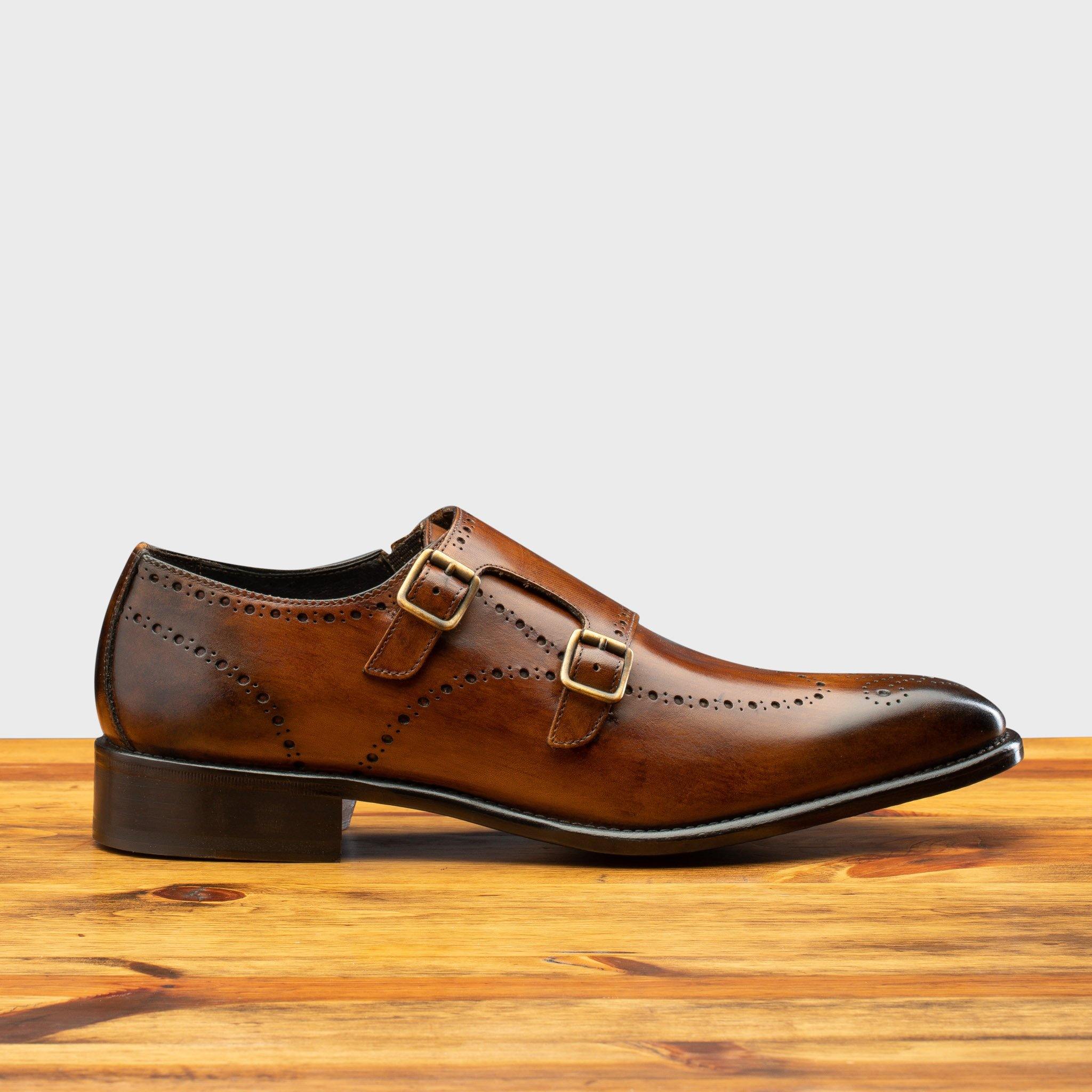 Side profile of 8863 Calzoleria Toscana Chestnut Cayenne Calf Double Monkstrap on top of a wooden table