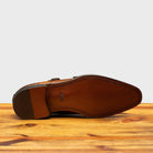 Full leather outsole of 8863 Calzoleria Toscana Chestnut Cayenne Calf Double Monkstrap on top of a wooden table