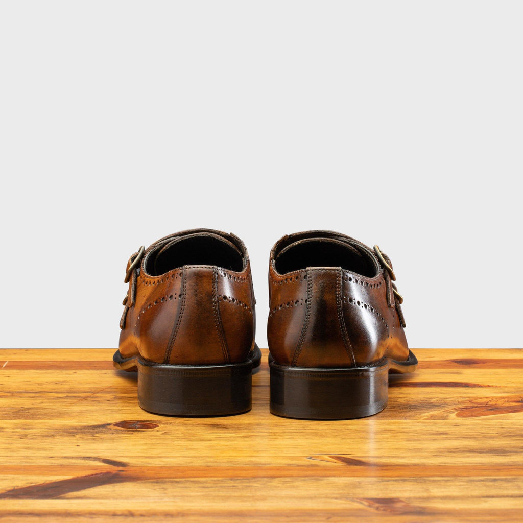 Back profile of 8863 Calzoleria Toscana Chestnut Cayenne Calf Double Monkstrap on top of a wooden table