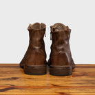 Pair of Moor leather boots on a wooden surface with a light gray background