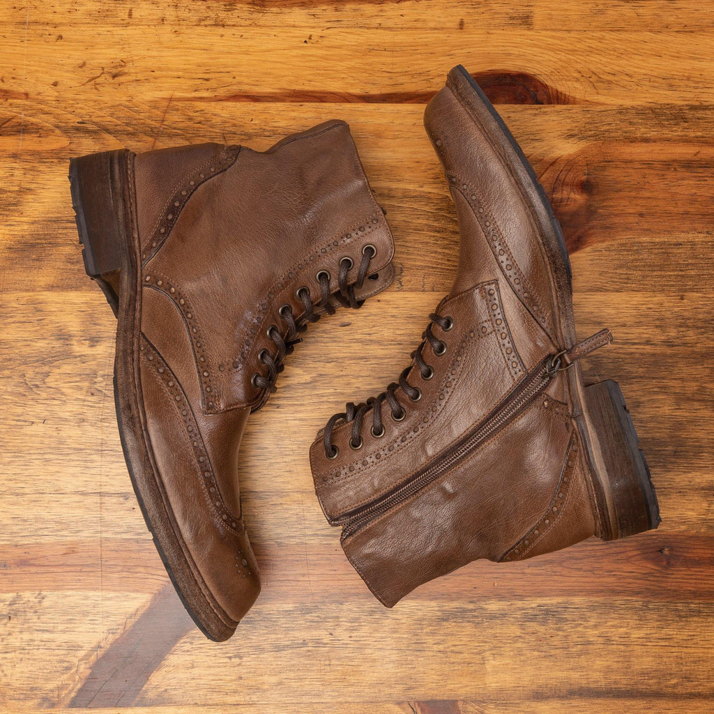 Pair of 9147 Calzoleria Toscana Moor Dip-Dyed Cesar Boot laying on the table showing the side profile and functional zipper on top of a wooden table