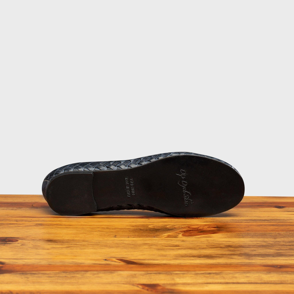 Full leather outsole of B940 Calzoleria Toscana Navy Melania Ballerina on top of a wooden table 