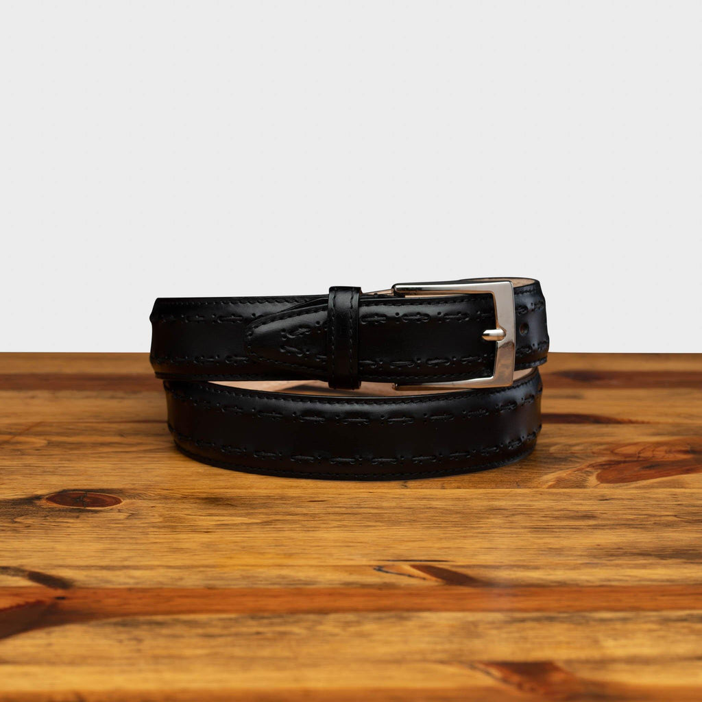 Picture of C1482 Calzoleria Toscana Black Stitched Dress Belt curled up on top of a wooden table