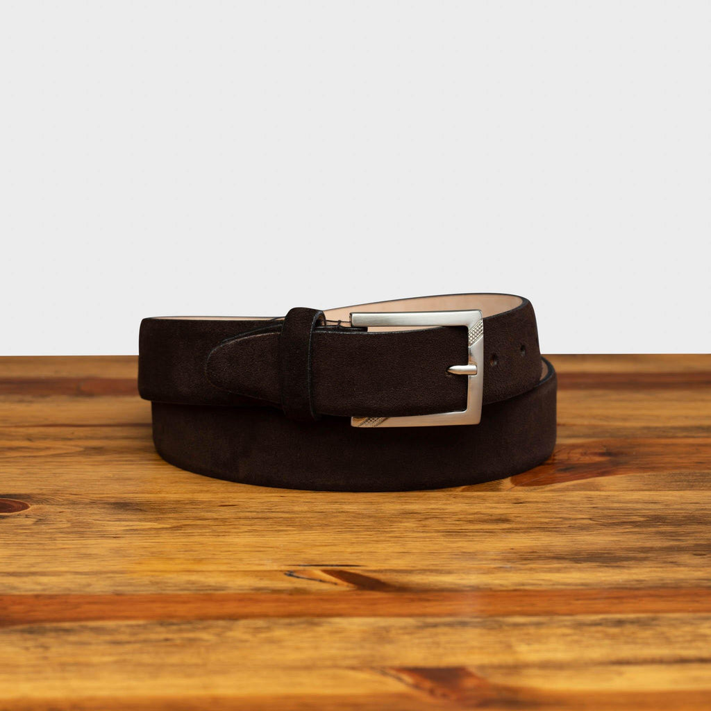Front profile of C1499-S Chocolate Velour Suede Belt curled on top of a wooden table