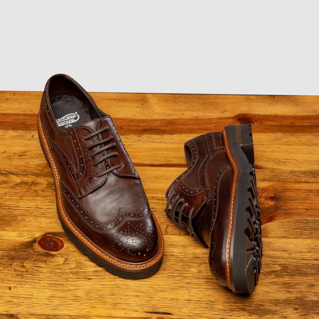 Pair of D277 Calzoleria Toscana Women's Brown Dip-Dyed Wingtip on top of a wooden table