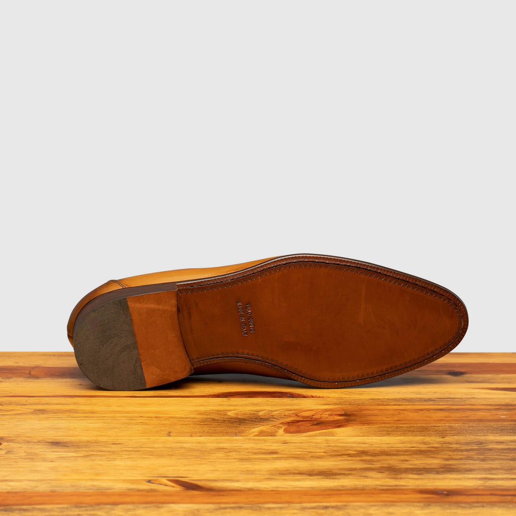 Full leather outsole of H614 Calzoleria Toscana Chestnut Tassel Slip-On on top a wooden table