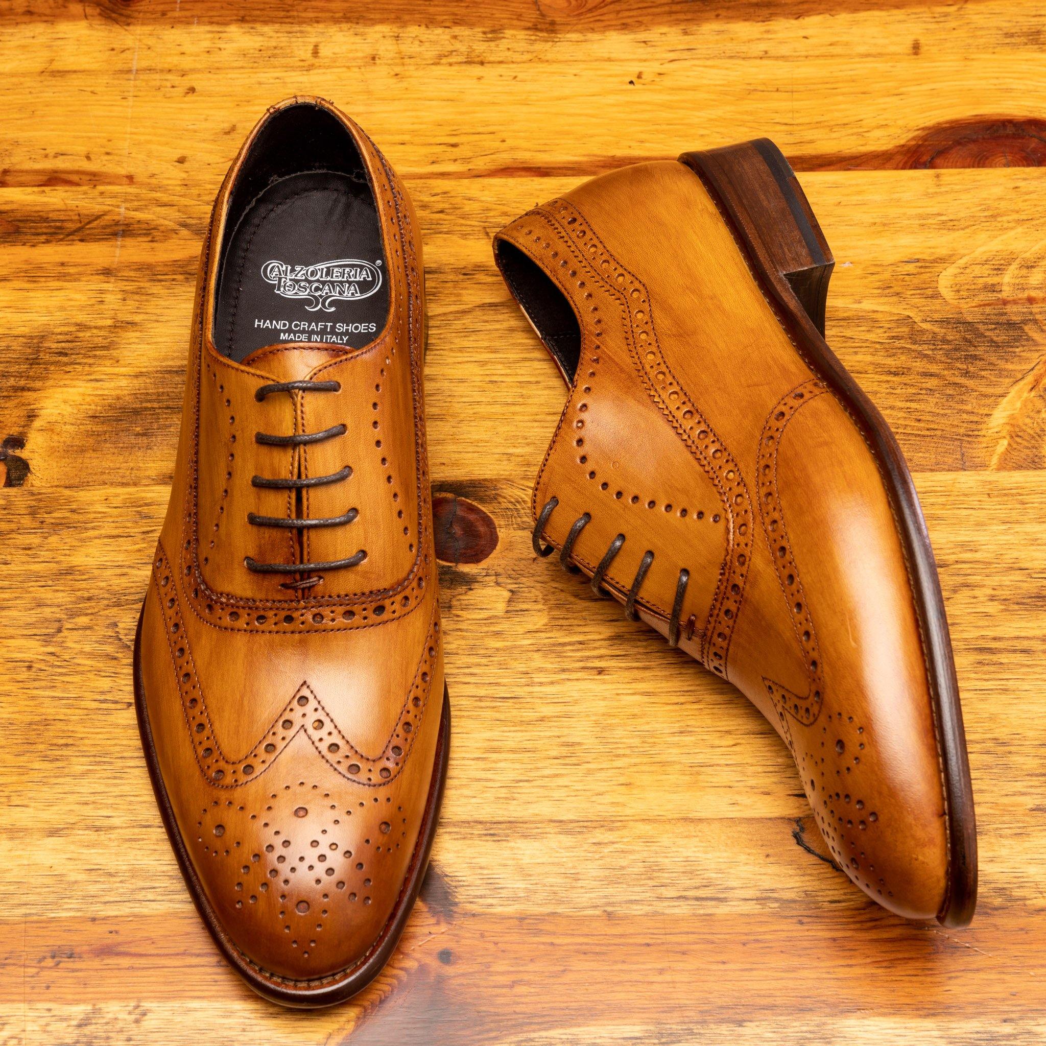 Pair of H742 Calzoleria Toscana Dark Caramel Balmoral Lace-up showing the brand name label on top of a wooden table