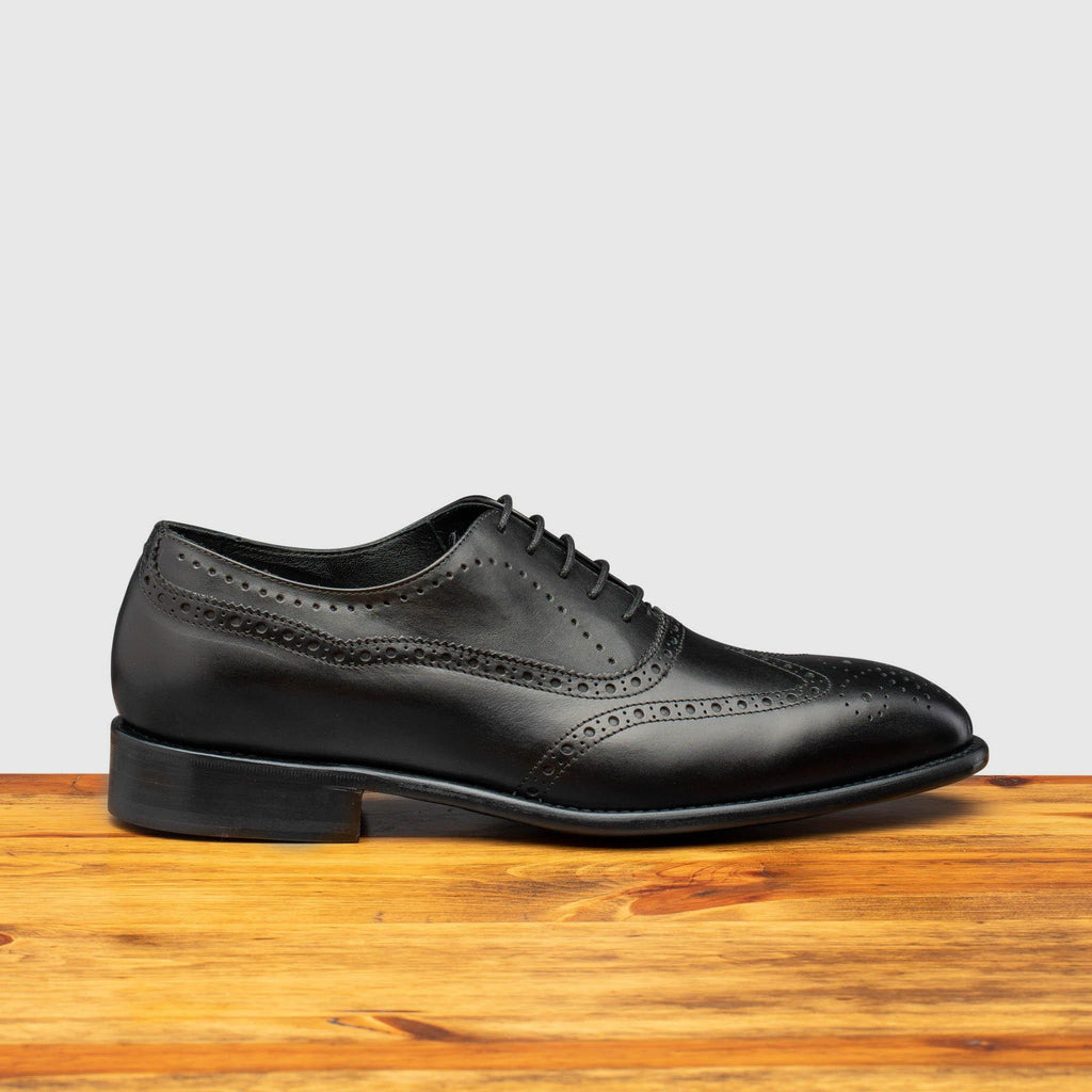 Side profile of H742 Calzoleria Toscana Black Balmoral Lace-up on top of a wooden table