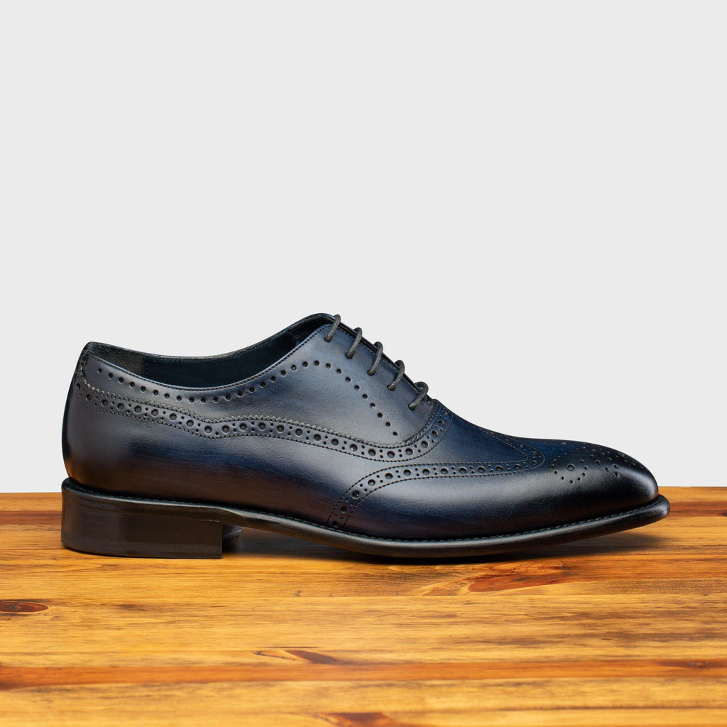 Side profile of H742 Calzoleria Toscana Blue Balmoral Lace-up on top of a wooden table