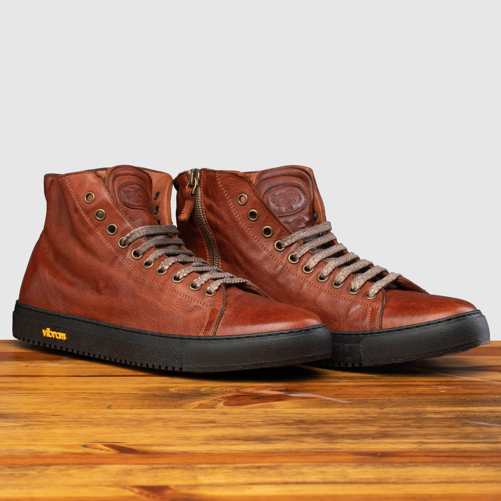 Pair of H883 Calzoleria Toscana Coker High Top Benso Sneaker on top of a wooden table