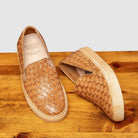 Pair of 9576 Calzoleria Toscana Women's Brick Dip-Dyed Woven Sneaker showing the brand name label on top of a wooden table