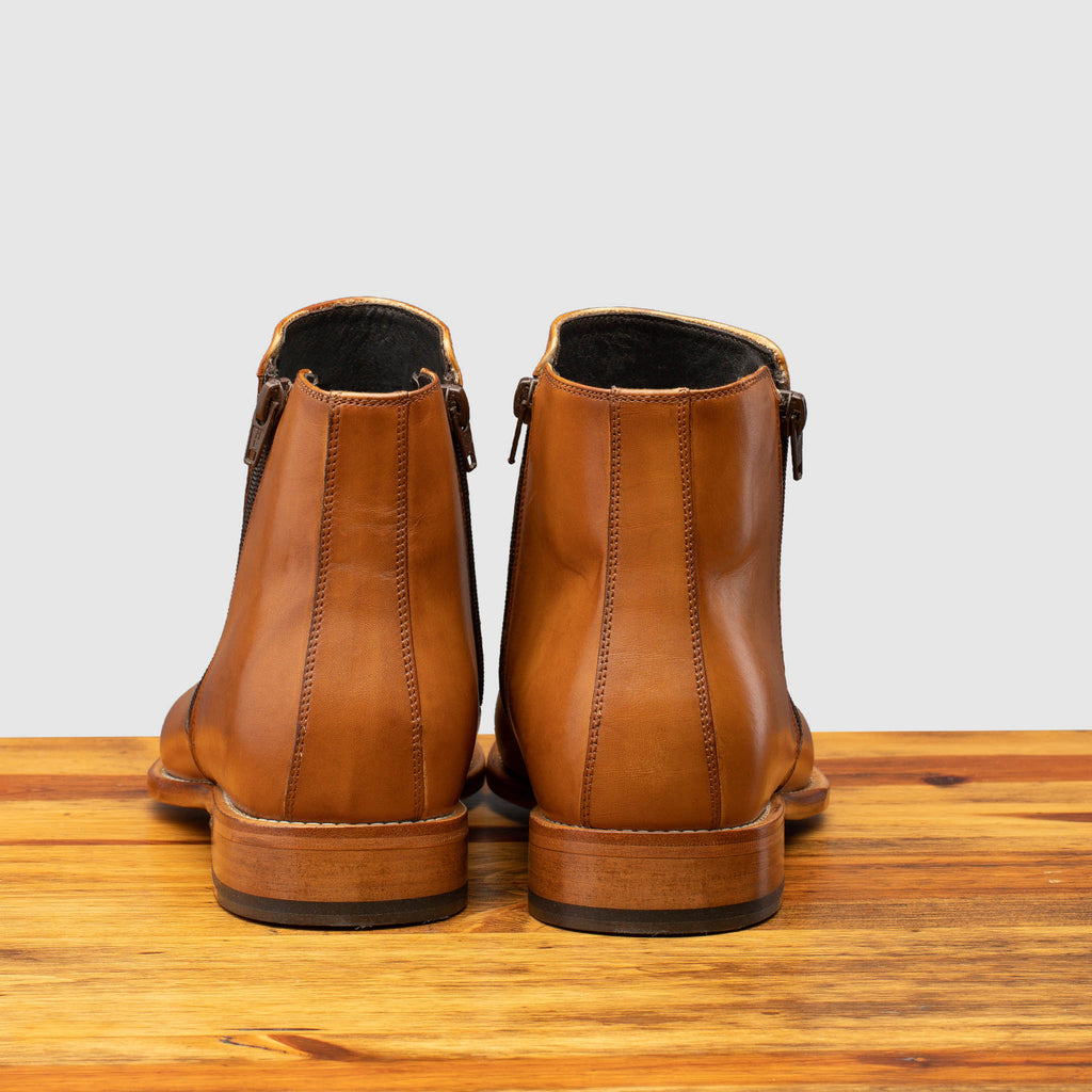 Back profile of Q337 Calzoleria Toscana Chester Onice Double Zipper Boot on top of a wooden table