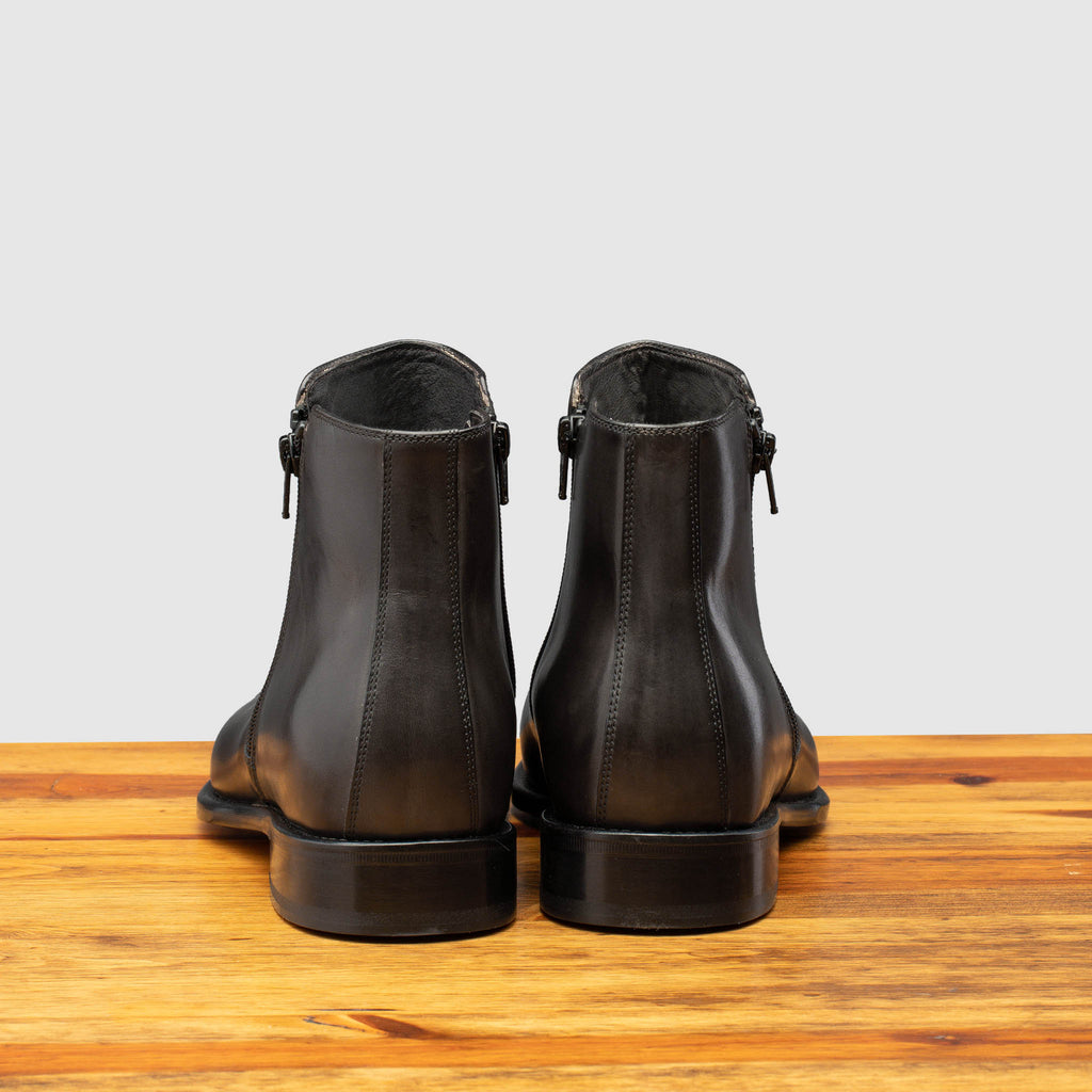 Back profile of Q337 Calzoleria Toscana Stone Onice Double Zipper Boot on top of a wooden table