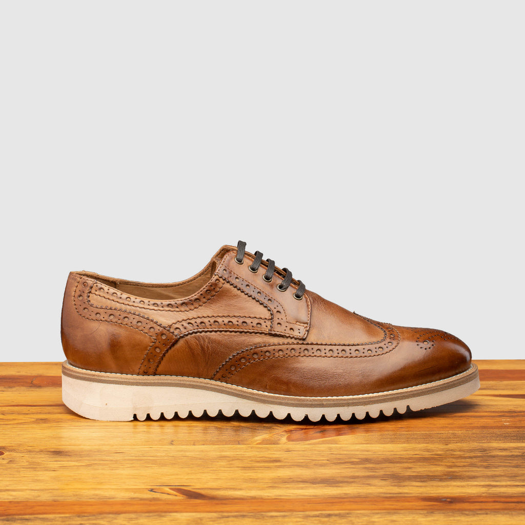 Side profile of Q399 Calzoleria Toscana Cerris Agos Wingtip Blucher on top of a wooden table